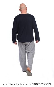 Rear View Of A Man In Pajamas Walking On White Background,