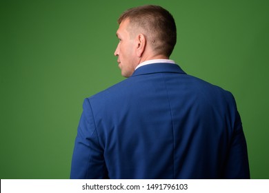 Rear view of mature macho businessman in suit - Powered by Shutterstock