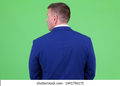 Rear view of mature macho businessman in suit - Powered by Shutterstock