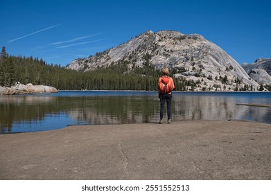 Rear view of mature woman standing on the lake shore - Powered by Shutterstock