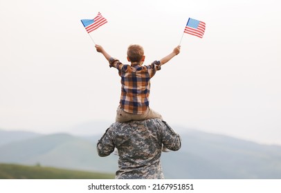 Rear View Of Military Man Father Carrying Happy Little Son With American Flag On Shoulders And Enjoying Amazing Summer Nature View On Sunny Day, Happy Male Soldier Dad Reunited With Son After US Army