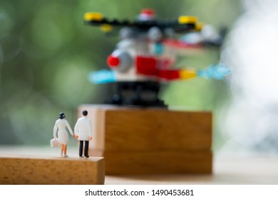 Rear View Of Miniature Doctor And Nurse Walking Towards Helicopter. Concept Of Emergency In Fast And Concept Of Business Insurance