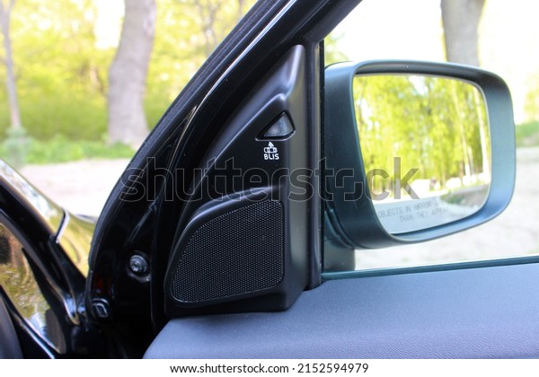 Rear view mirror with blind spot sensor. In side\
rear-view mirror on a car.