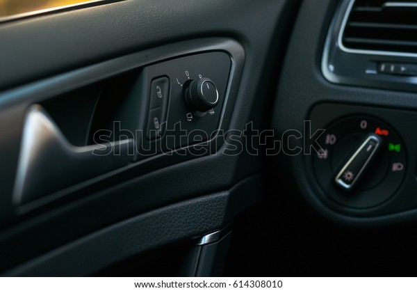 Rear view mirror control, door handle and headlight\
control unit.