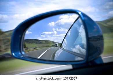 Rear View Mirror Reflecting Road And Sky