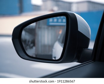 The Rear View Mirror Of An SUV And The Scene Inside