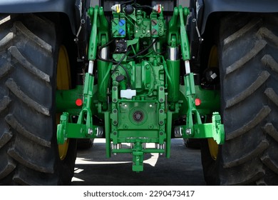 Rear view of a modern industrial tractor painted in green. Mechanisms and control units for additional equipment. - Shutterstock ID 2290473417