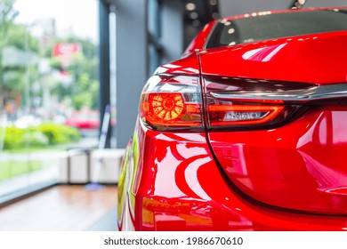 Rear View Of New Modern Red Car Led Tail Lights In Showroom