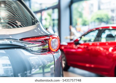 Rear View Of New Modern Silver Car Led Tail Lights In Showroom