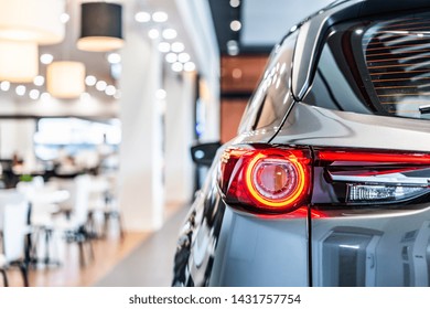 Rear View Of New Modern Silver Car Led Tail Lights In Showroom