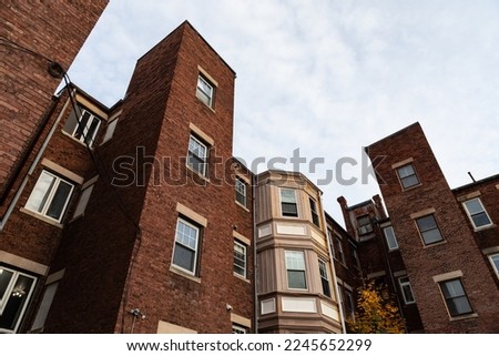 Rear view of old brick apartment buildings showing a wide variety of shapes and styles, horizontal aspect