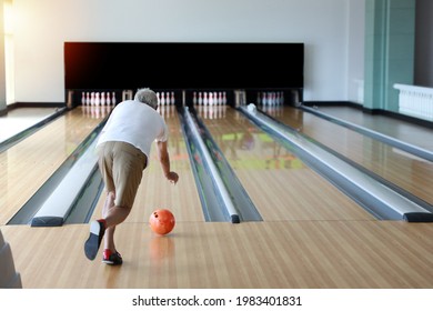 Rear View Older Caucasian Men, White Beard And White Hair In White And Blue Shirt Playing Bowling In Sport Club