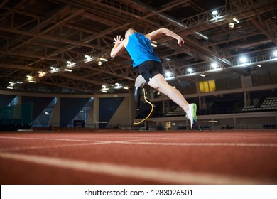 Rear View Of Paralympic Runner Over Race Track Moving Forwards During Marathon At Stadium