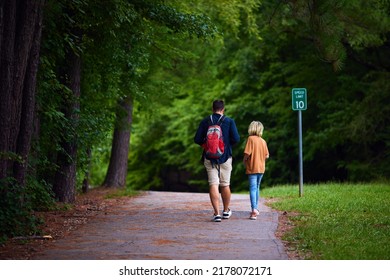 rear view of people walking along the trail in city park - Shutterstock ID 2178072171