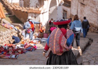Rear view of peruvian indigenous woman dressed in traditional colorful clothes - Shutterstock ID 2309281189