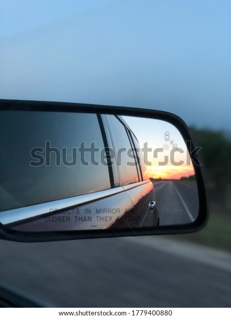 Rear view photo\
of a setting sun in West\
Texas