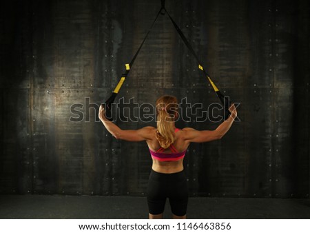 Similar – Image, Stock Photo Rear view portrait of one young middle age athletic woman at crossfit training, exercising with trx suspension fitness straps over dark background