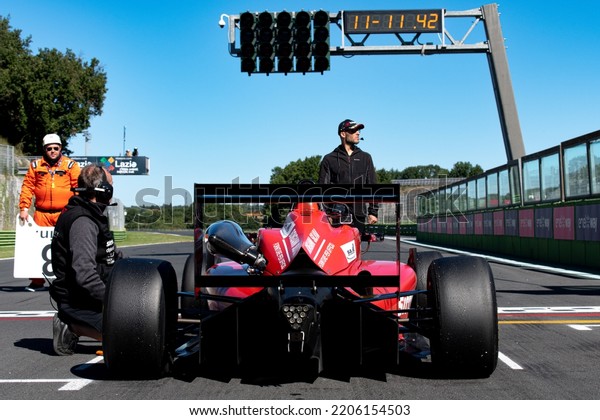 Rear view of racing formula car\
standing in racetrack starting grid pole position driver point of\
view. Vallelunga, Italy, september 17-18 2022, Racing\
weekend