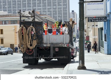 Rear View Of Repair Utility Truck Parked On Urban Street. Horizontal.