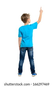 Rear view of a school boy over white background pointing upwards. Full length portrait