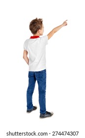 Rear view of a school boy over white background pointing upwards. Full length portrait