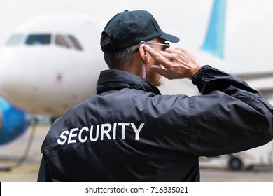 Rear View Of A Security Guard Wearing Black Jacket