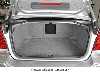 Rear view of a sedan car with open trunk