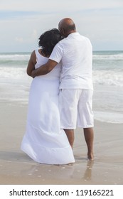 Rear view of senior African American man and woman couple on a deserted tropical beach