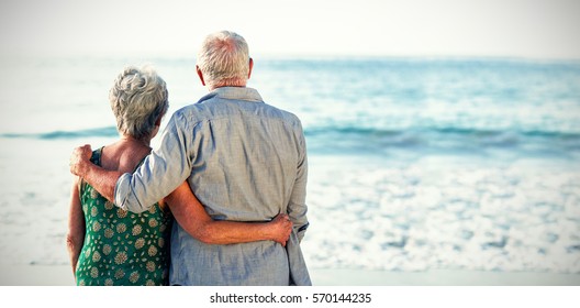 Rear View Of Senior Couple At Beach Against Sea