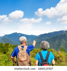 Rear View  Senior  Couple Hiking On The Mountain 