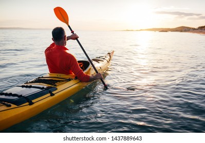 Rear view of senior man paddling kayak, copy space