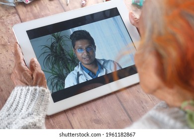 Rear View Of Senior Women Online Consultation With Doctor On Digital Tablet 