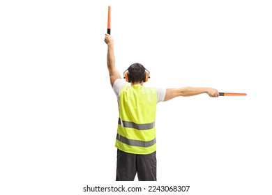 Rear view shot of an aircraft marshaller signalling with wands isolated on white background