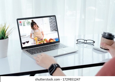 Rear View Shot, Asian Woman Watching Live Video Steaming Online Chef Teach Cooking Food Prepare With Vegetable Healthy Diet Menu And Many Fruit For Dinner, Staying From Home Self-isolation Concept.