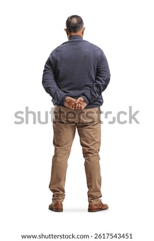 Rear view shot of a man standing with arms behind back isolated on white background