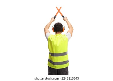 Rear view shot of an marshaller signalling with crossed wands isolated on white background