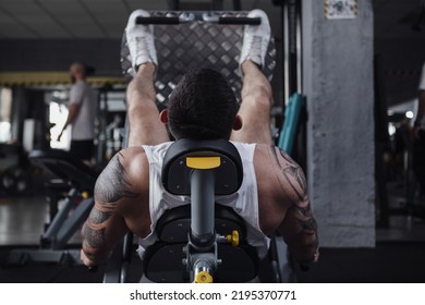 Rear View Shot Of Unrecognizable Male Athlete Doing Leg Press Exercise