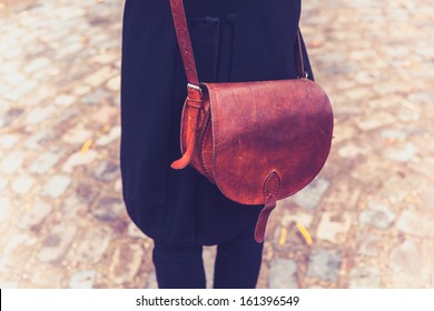 Rear View Shot Of Woman With Leather Handbag