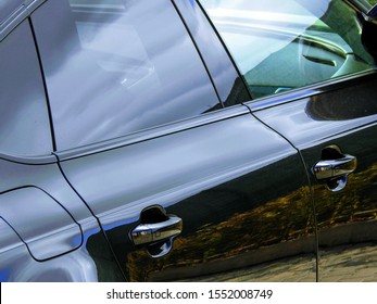 Rear view of the side doors of a shiny polished black car