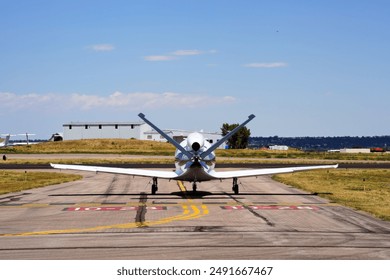 A Rear View of a Single Engine Jet Airplane Taxiing at an Airport