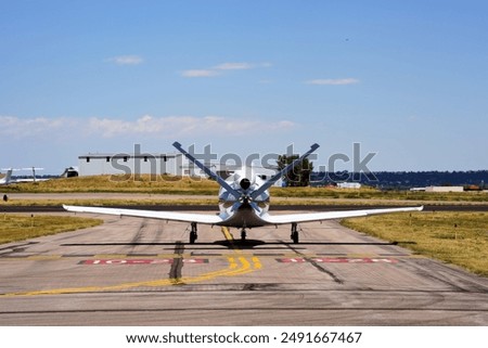 A Rear View of a Single Engine Jet Airplane Taxiing at an Airport
