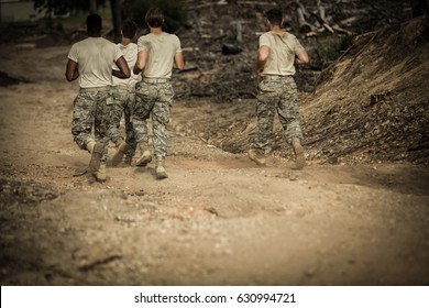 Rear view of Soldiers running in boot camp - Powered by Shutterstock