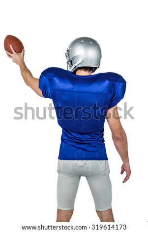 Rear view of sports player holding ball against white background