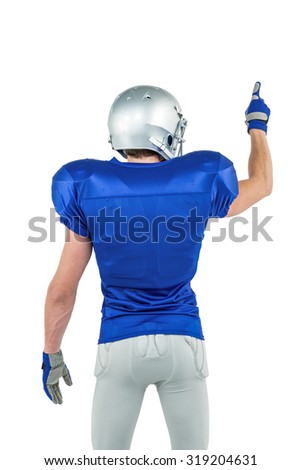 Rear view of sports player pointing against white background