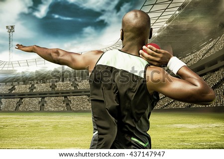 Rear view sportsman practising shot put against view of a stadium
