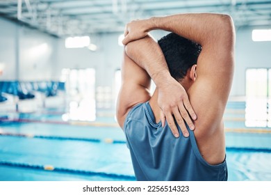 Rear view, stretching and man at swimming pool for training, cardio and exercise, indoor and flexible. Hand, back and swimmer stretch before workout, swim and fitness routine, warm up and preparation - Powered by Shutterstock