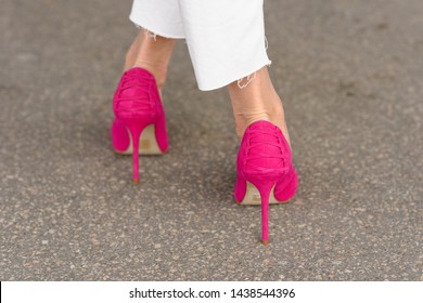 Rear View Of A Stylish Woman Wearing Pink Stiletto Shoes Showing The Very High Thin Heels On Tar