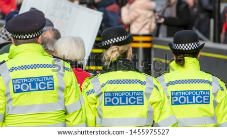 Rear View of Three Uniformed Metropolitan Police Officers in London, England
