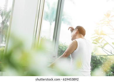 Rear View Tired Asian Old Man Wiping Sweat With His Hand While Running Or Jogging On Treadmill At The Gym. Exercise, Workout, Health Care Concepts. Copy Space.