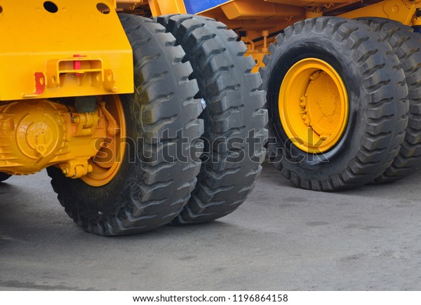 Rear\
view of the tires of a large yellow mining\
truck